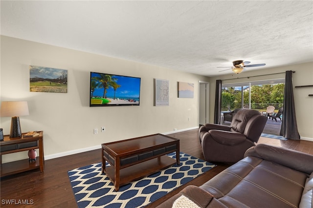 living area with a ceiling fan, a textured ceiling, baseboards, and dark wood-style flooring