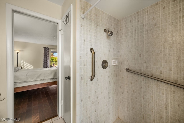 full bathroom with tiled shower and connected bathroom