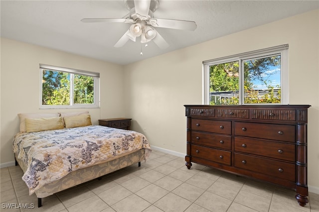 bedroom featuring ceiling fan, baseboards, and light tile patterned floors