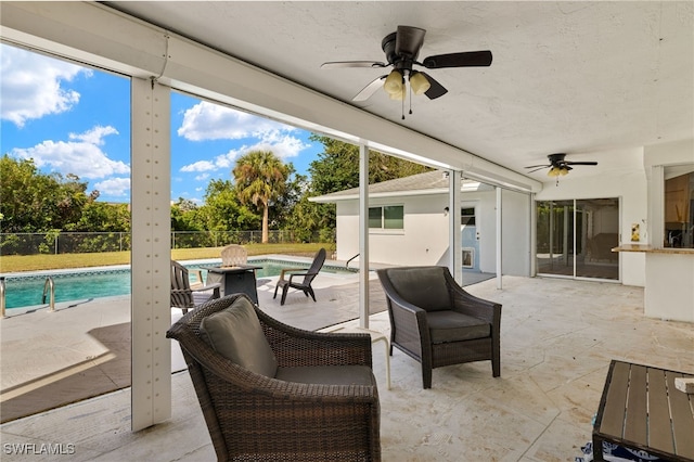 view of patio featuring fence, a fenced in pool, and a ceiling fan