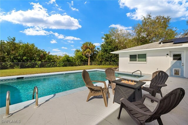 view of swimming pool with a yard, an outdoor fire pit, and a patio