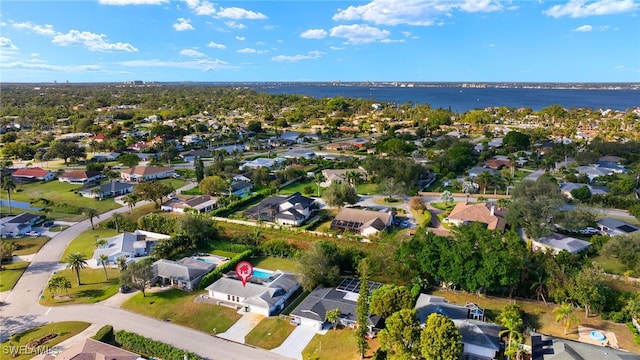 drone / aerial view with a residential view and a water view