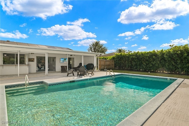 view of pool with a patio area, fence, and a fenced in pool