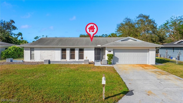 single story home featuring driveway, a front lawn, and an attached garage