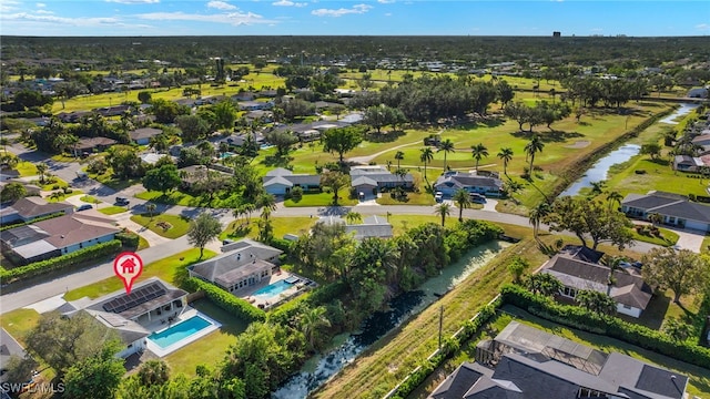 birds eye view of property with a water view and a residential view