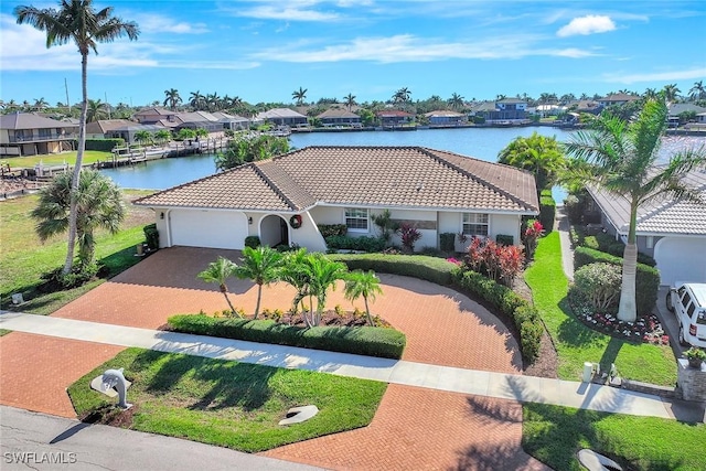 view of front of house with a water view and a garage