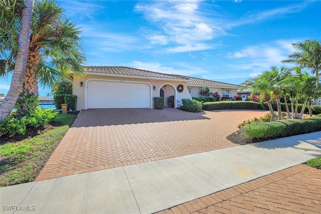 mediterranean / spanish home with a garage