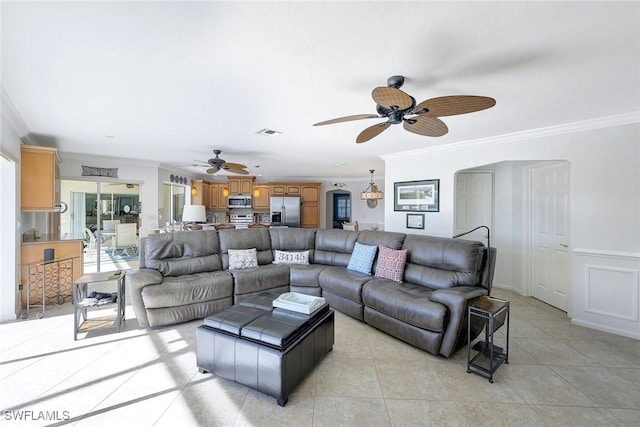 living room with light tile patterned floors and crown molding