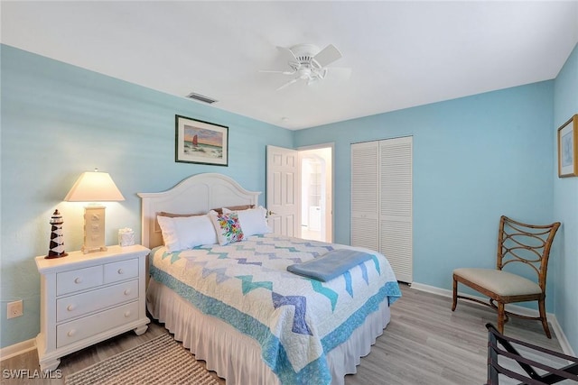 bedroom with a closet, ceiling fan, and light hardwood / wood-style floors