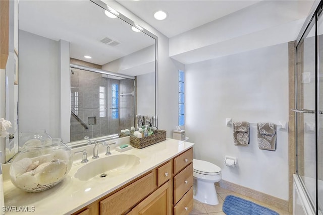 bathroom featuring tile patterned floors, vanity, and toilet