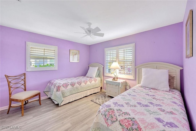 bedroom with ceiling fan and light hardwood / wood-style flooring