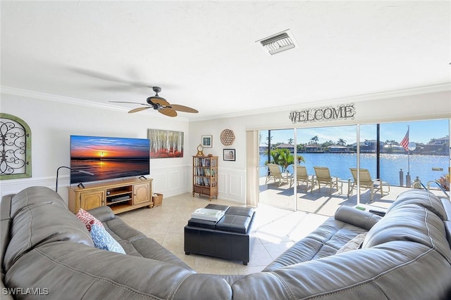 living room featuring ceiling fan, ornamental molding, and light tile patterned flooring