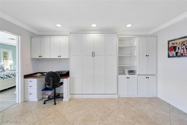 office space featuring crown molding and built in desk