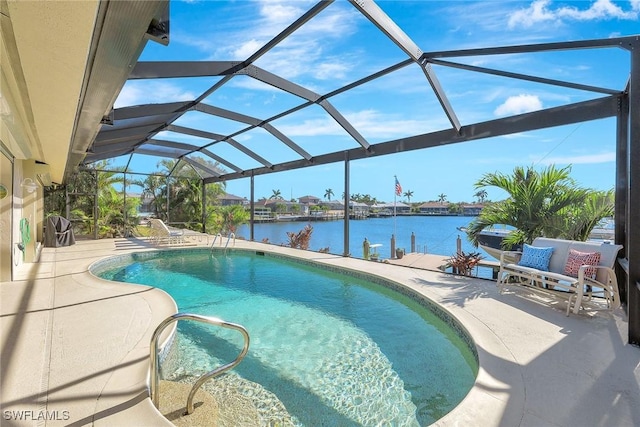 view of swimming pool featuring glass enclosure, a patio area, and a water view