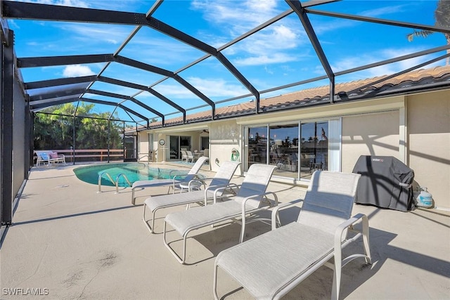 view of pool featuring a lanai, grilling area, and a patio area