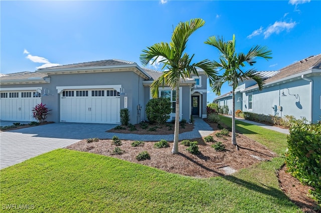 view of front facade featuring a front yard and a garage