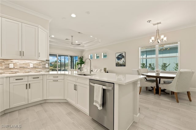 kitchen with white cabinetry, sink, stainless steel dishwasher, kitchen peninsula, and ceiling fan with notable chandelier