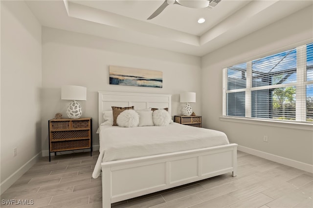 bedroom featuring a tray ceiling and ceiling fan