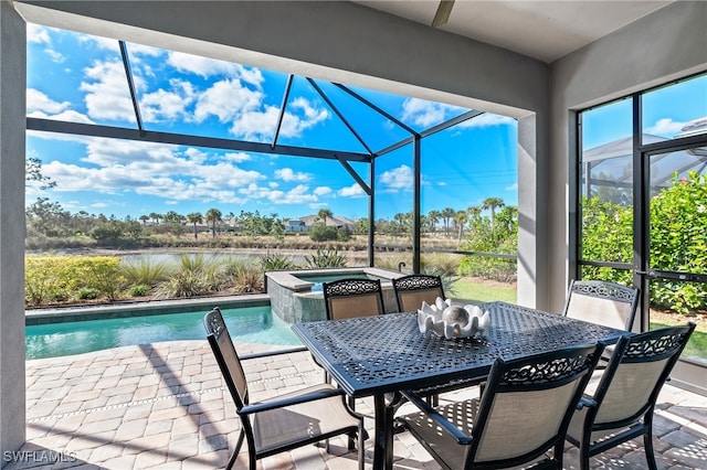 view of patio featuring a lanai and a pool with hot tub