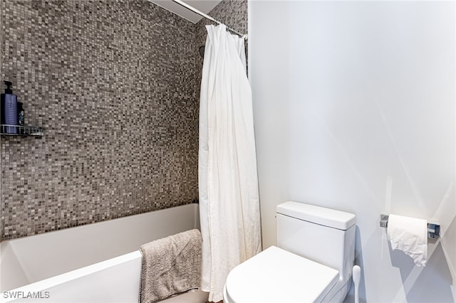 bathroom featuring shower / bath combination with curtain and toilet