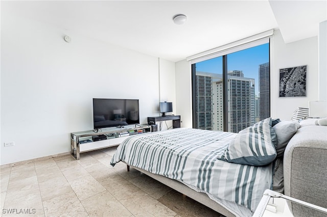 bedroom featuring a wall of windows