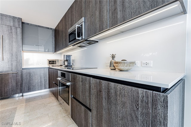 kitchen featuring dark brown cabinets and appliances with stainless steel finishes