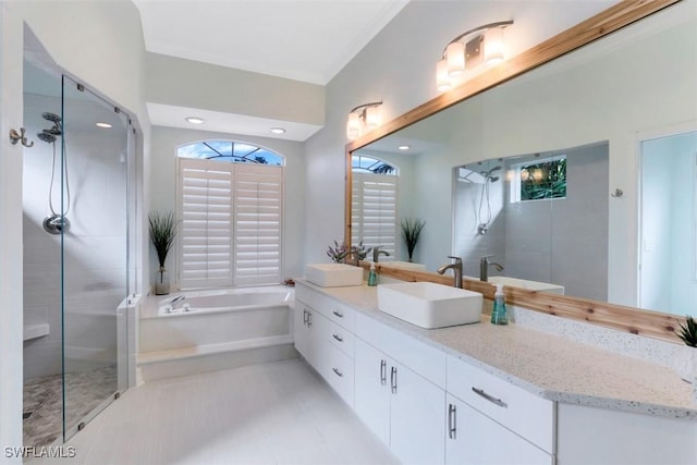 bathroom with tile patterned flooring, vanity, and shower with separate bathtub