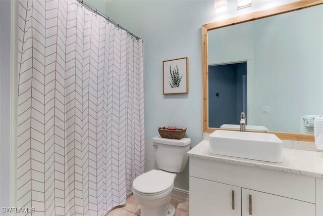 bathroom featuring curtained shower, tile patterned flooring, vanity, and toilet