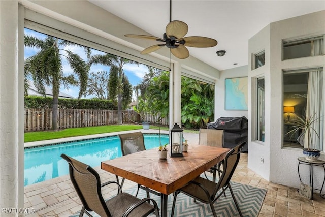 view of pool featuring ceiling fan, a patio, and grilling area