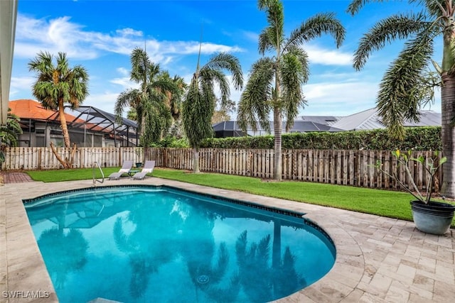 view of swimming pool featuring a lanai