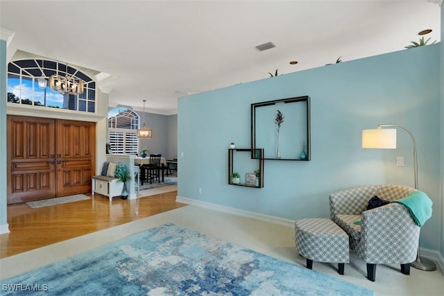 foyer entrance with hardwood / wood-style flooring and an inviting chandelier