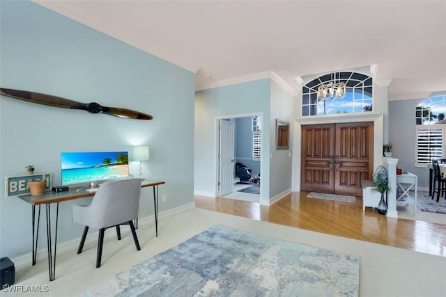 interior space with crown molding, light wood-type flooring, and an inviting chandelier