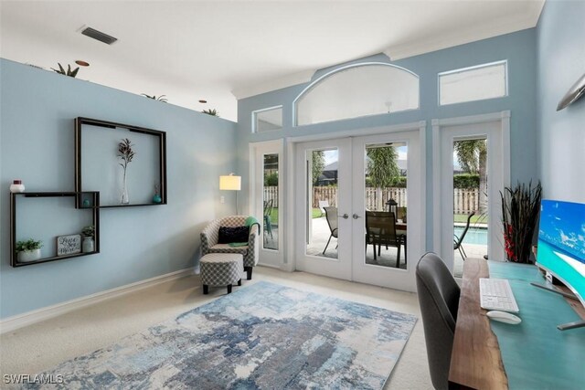 sitting room with light carpet and french doors