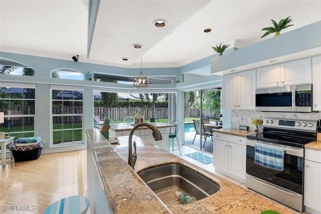 kitchen featuring white cabinets, sink, and stainless steel appliances