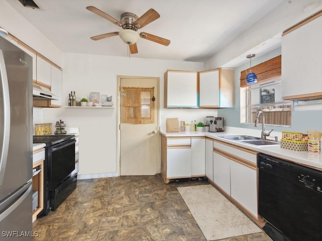 kitchen featuring black appliances, decorative light fixtures, white cabinetry, and sink