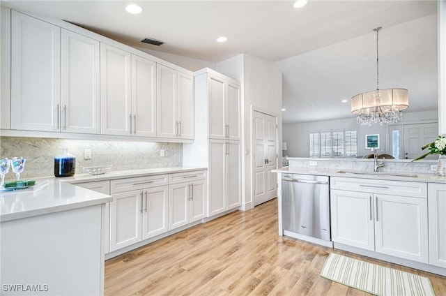 kitchen featuring sink, pendant lighting, white cabinetry, and dishwasher