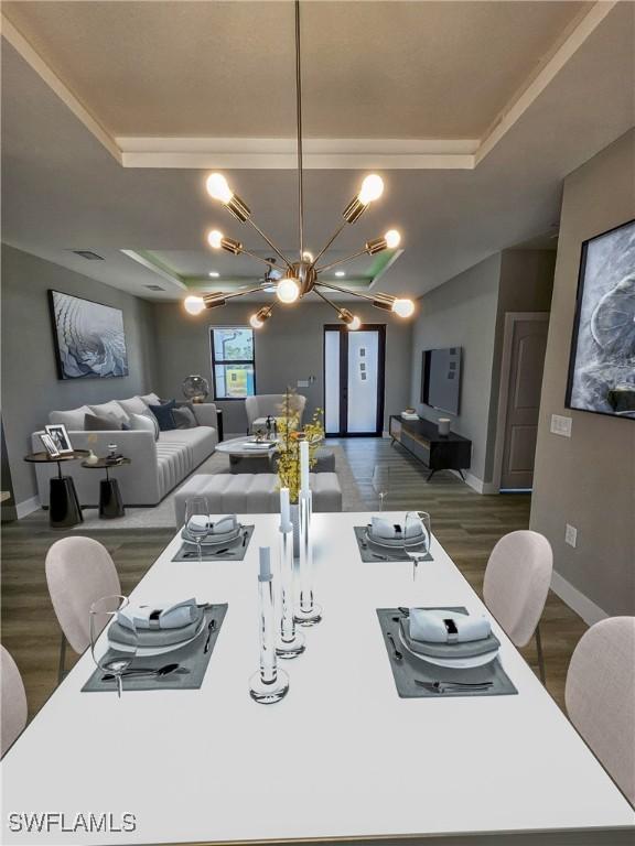 dining space with a chandelier, a raised ceiling, and dark wood-type flooring