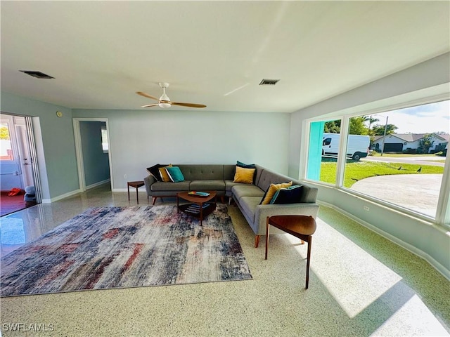 living room with ceiling fan and a wealth of natural light