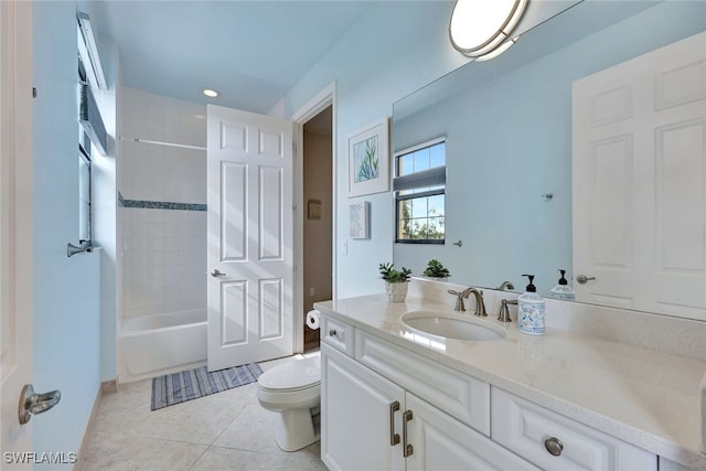 full bathroom featuring tile patterned flooring, vanity, tiled shower / bath, and toilet