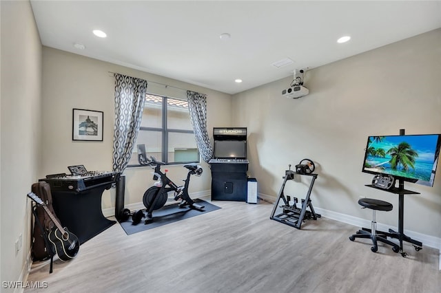 workout area with wood-type flooring