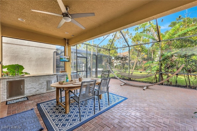 view of patio with ceiling fan and exterior kitchen