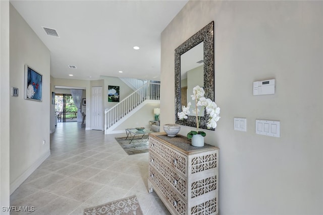 hall featuring light tile patterned floors