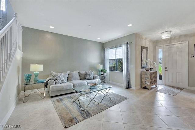 living room with light tile patterned floors and an inviting chandelier