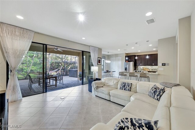 tiled living room with ceiling fan