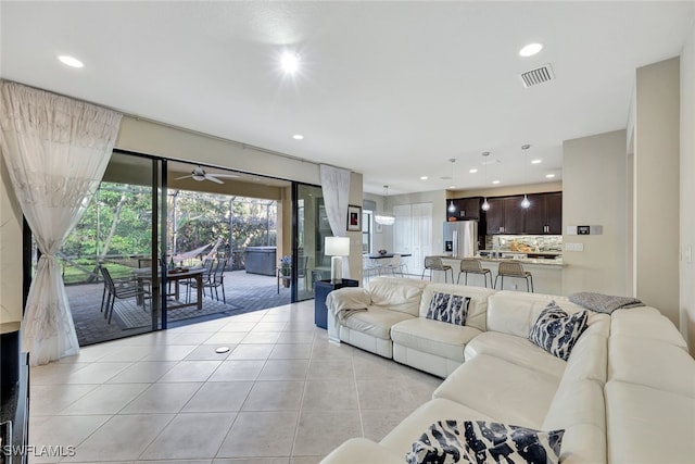 tiled living room with ceiling fan