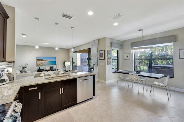 kitchen featuring sink, appliances with stainless steel finishes, hanging light fixtures, dark brown cabinetry, and light stone countertops