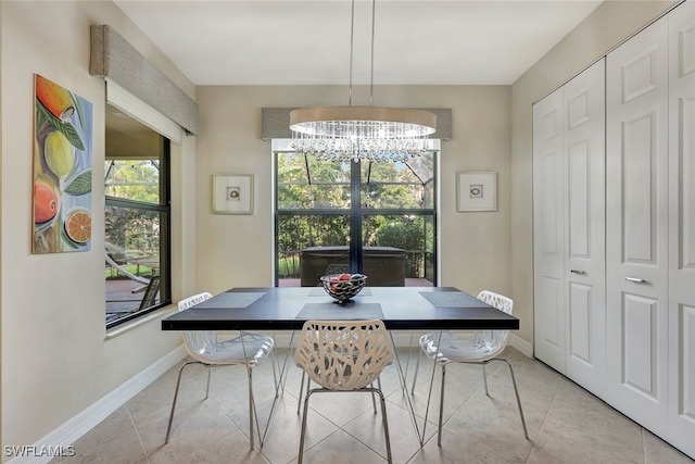 dining area featuring a notable chandelier and light tile patterned floors