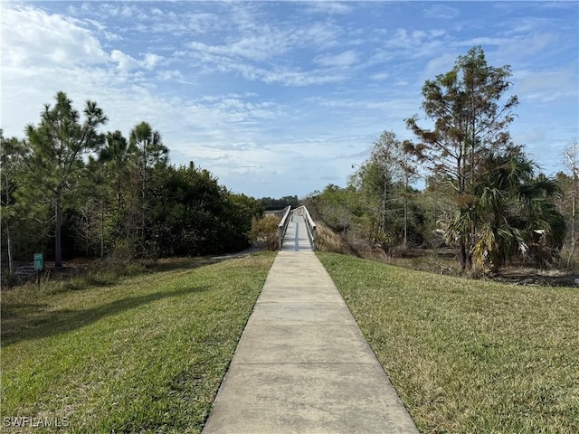 view of property's community featuring a yard