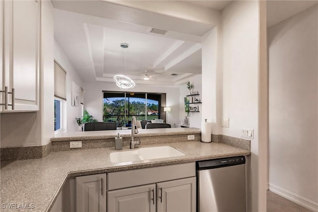 kitchen with white cabinets, tile patterned floors, stainless steel dishwasher, and sink