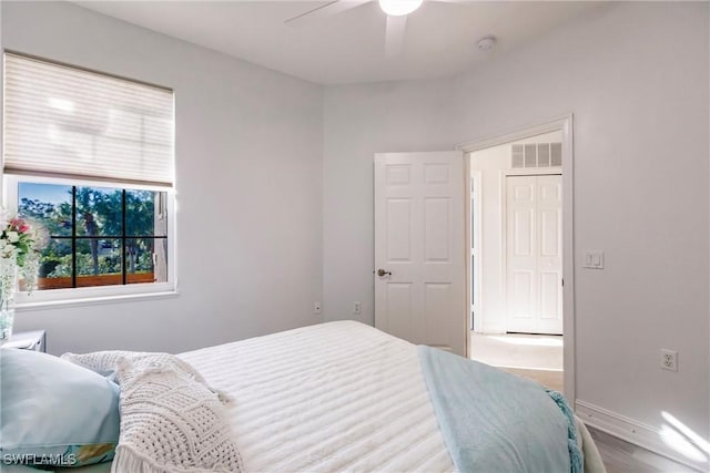 bedroom with ceiling fan and light hardwood / wood-style floors